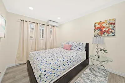 a bedroom with a bed and a glass table at Cozy & Serene ~ 12mins to Downtown LA in Alhambra