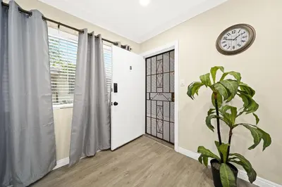 a room with a clock on the wall and a plant at Cozy & Serene ~ 12mins to Downtown LA in Alhambra