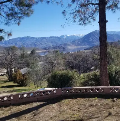 a bridge over a river with mountains in the background at Lake Isabella View, Wofford Heights, Kern County in Wofford Heights