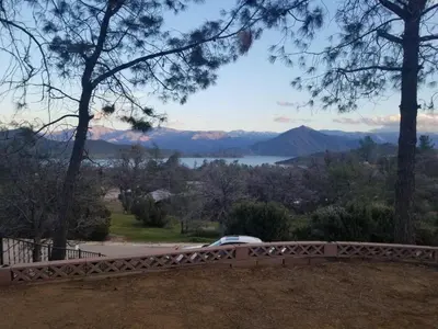 a car on a bridge with a view of the mountains at Lake Isabella View, Wofford Heights, Kern County in Wofford Heights