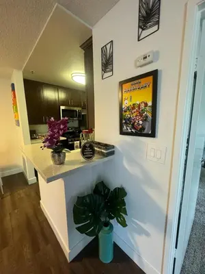 a kitchen with a counter with a potted plant at Mario, Disney & not themed Loft Universal Studios 10min loft apartment in Los Angeles