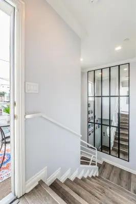a staircase in a house with white walls and a window at Angel & Rose * Hollywood DTLA in Los Angeles