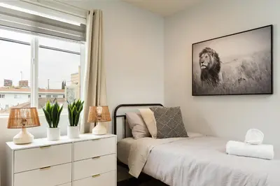 a bedroom with a bed and a dresser and a window at Angel & Rose * Hollywood DTLA in Los Angeles