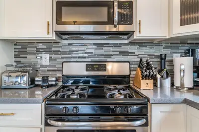 a kitchen with a stove and a microwave at Angel & Rose * Hollywood DTLA in Los Angeles