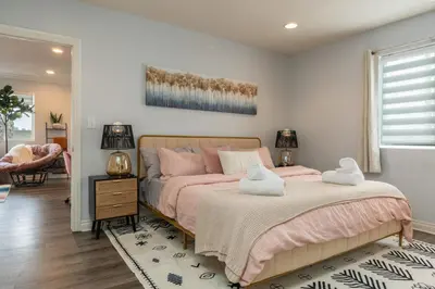 a bedroom with a bed with pink pillows at Angel & Rose * Hollywood DTLA in Los Angeles