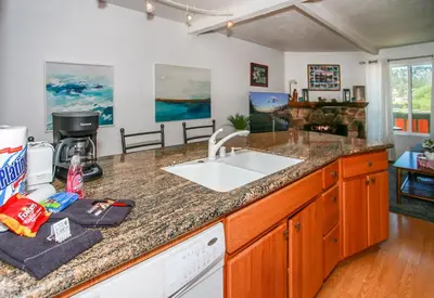 a kitchen with a sink and a counter top at Bayview Condo - Condo is cozy and a great location for kayaking and paddle boarding! in Big Bear Lake