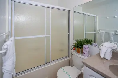 a bathroom with a toilet and a glass shower at Bayview Condo - Condo is cozy and a great location for kayaking and paddle boarding! in Big Bear Lake