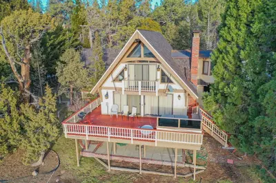 an overhead view of a house in the woods at Alpine Lakefront - Lakefront cabin and all the amenities really fun from the pool table and spa in Big Bear Lake