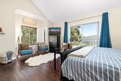 a bedroom with a bed and a desk and a window at BB Lake View Lodge - Gorgeous Lakeviews, Hot Tub, Jetted Tub, and Firepit! in Big Bear Lake