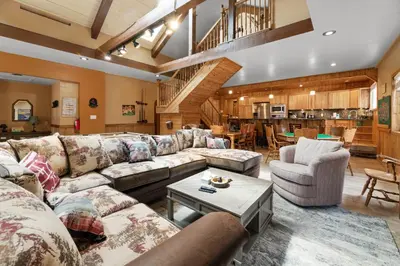 a large living room with couches and a table at Bear Family Cabin - Stay together & play together! Foosball, billiards, hot tub, walk to lake! in Big Bear Lake
