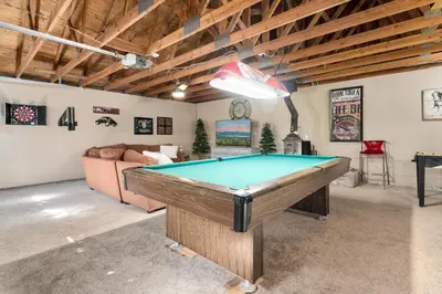 a living room with a pool table in it at Bear PAC Hideout - Walk to Alpine Slide and only minuetes to The Village! Billiards and foosball! in Big Bear Lake