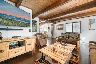 a living room with a couch and a table at Bear PAC Hideout - Walk to Alpine Slide and only minuetes to The Village! Billiards and foosball! in Big Bear Lake