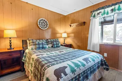 a bedroom with a bed and a window at Bear Paw Cabin - Cozy and quaint, the perfect mountain getaway! in Big Bear Lake