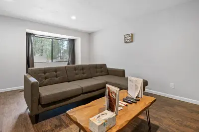 a living room with a couch and a coffee table at Bear Retreat - Modern location within walking distance to Snow Summit with a private hot tub! in Big Bear Lake