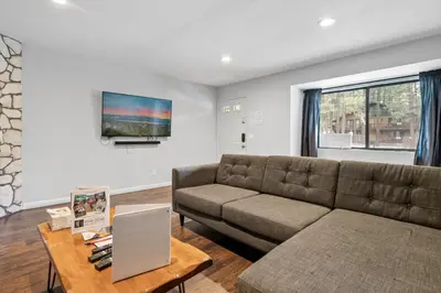 a living room with a couch and a table at Bear Retreat - Modern location within walking distance to Snow Summit with a private hot tub! in Big Bear Lake