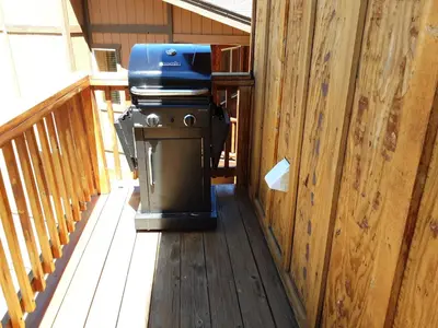 a grill sitting on a deck on a porch at Ben's Cool Cabin - Phenomenal views and an ideal location close to all the local attractions! in Big Bear Lake