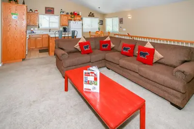 a living room with two couches and a red table at Ben's Cool Cabin - Phenomenal views and an ideal location close to all the local attractions! in Big Bear Lake