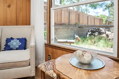 a table with a bowl on top of it next to a window at Big Bear Bungalow - Modern aesthetics meet mountain charm in this newly remodeled two-story home in Big Bear Lake