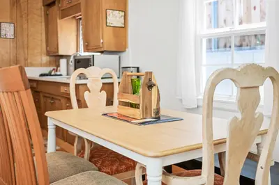 a kitchen table with two chairs and a box on it at Big Bear Bungalow - Modern aesthetics meet mountain charm in this newly remodeled two-story home in Big Bear Lake