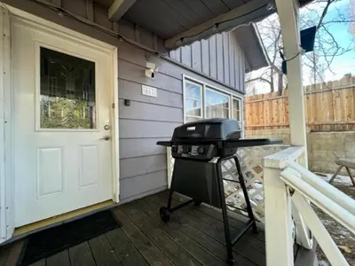 a grill on the porch of a house at Big Bear Bungalow - Modern aesthetics meet mountain charm in this newly remodeled two-story home in Big Bear Lake