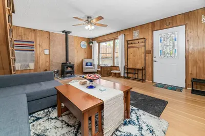 a living room with a couch and a table at Big Bear Bungalow - Modern aesthetics meet mountain charm in this newly remodeled two-story home in Big Bear Lake