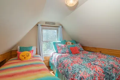 a bedroom with two beds and a window at Big Bear Retreat - A charming mountain cabin with easy access to Big Bear's attractions! in Big Bear Lake