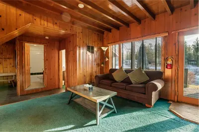 a living room with a couch and a table at Blue Lagoon - Classic Lakefront Cabin with Pool Table! in Big Bear Lake