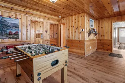 a game room with a foosball table in a log cabin at Boulder Bay Lakefront Getaway - Across the street from the lake and Boulder Bay Park! in Big Bear Lake