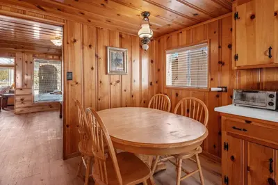 a wooden dining room with a wooden table and chairs at Boulder Bay Lakefront Getaway - Across the street from the lake and Boulder Bay Park! in Big Bear Lake