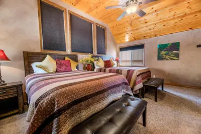 a bedroom with two beds and a ceiling fan at Boulder Bay Park Lakefront - Across the street from the lake and Boulder Bay Park! Hot tub! in Big Bear Lake