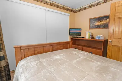 a bedroom with a bed and a large window at Boulder Pines - Walk to lake and Boulder Bay park at those cozy location! in Big Bear Lake