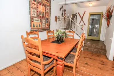 a dining room with a wooden table and chairs at Brown Bear's Den - Spacious condo within walking distance to all Big Bear has to offer! in Big Bear Lake