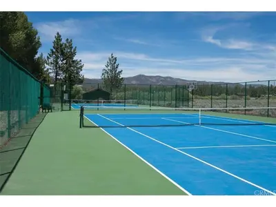 a tennis court with two tennis on at Brown Bear's Den - Spacious condo within walking distance to all Big Bear has to offer! in Big Bear Lake