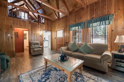 a living room with a couch and a coffee table at Chalet Des Ours -Comfortable and spacious home with WIFI! Close to everything! in Big Bear Lake