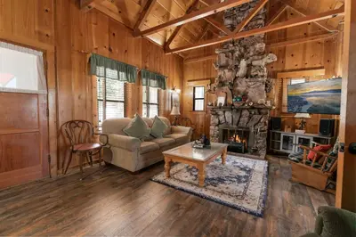 a living room with a couch and a fireplace at Chalet Des Ours -Comfortable and spacious home with WIFI! Close to everything! in Big Bear Lake