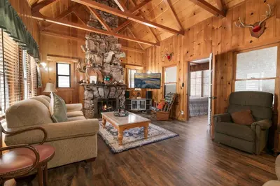 a living room with a couch and a fireplace at Chalet Des Ours -Comfortable and spacious home with WIFI! Close to everything! in Big Bear Lake