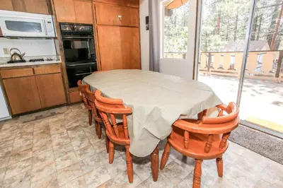 a kitchen with a table and chairs in a room at Chalet Georgia - Spacious and cozy home, conveniently close to the heart of Big Bear! in Big Bear Lake