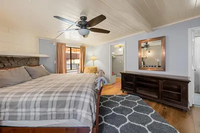 a bedroom with a bed and a ceiling fan at Chipmunk House - Magical Boulder Bay cottage within a picturesque setting! in Big Bear Lake