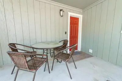 a table and chairs in a room with a red door at Cub Run Cabin - Spacious home close to the lake with Hot tub! in Big Bear Lake