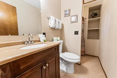 a bathroom with a white toilet and a sink at Cub Run Cabin - Spacious home close to the lake with Hot tub! in Big Bear Lake