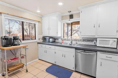 a kitchen with white cabinets and a sink at Dream Street Escape -Private Hot Tub, near the Village and Lake! in Big Bear Lake