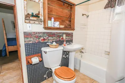 a bathroom with a toilet and a sink at Eagle's Den - Cozy cabin with a beautiful wood burning fireplace! Foosball Table! in Big Bear Lake