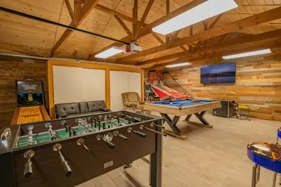 a living room with a foosball table and a ping pong table at Evergreen Paradise - Beautiful newly remodeled cabin with Hot Tub and Game Room! in Big Bear Lake