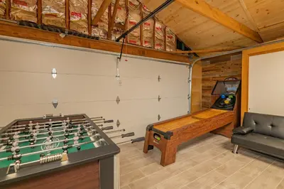 a room with a foosball table and a couch at Evergreen Paradise - Beautiful newly remodeled cabin with Hot Tub and Game Room! in Big Bear Lake