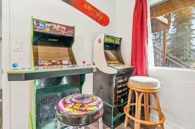 a video game room with a pinball machine at Family Fun Cabin - Mountain home with Game Room, Hot Tub and Lake Views! in Fawnskin