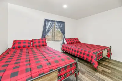 a bedroom with two beds and a window at Family Fun Cabin - Mountain home with Game Room, Hot Tub and Lake Views! in Fawnskin