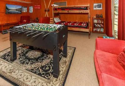 a living room with a foos ball on a table at Fawnskin Family Cabin - Nicely decorated cabin with a lake view and a Foosball Table! in Fawnskin