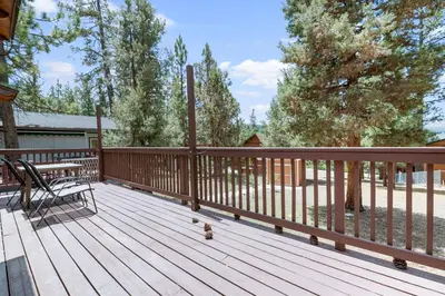 a wooden deck with a bench on it at Finch Nest - Beautiful cabin in a convenient location! in Big Bear Lake