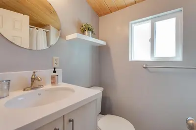 a bathroom with a sink and a mirror at Five Pines - Beautifully remodeled gambrel cabin with Hot Tub and Fenced Yard! in Big Bear Lake
