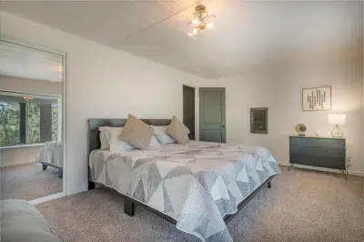a bedroom with a large bed in a room at Forest Escape - Situated on the quiet side of the lake, nicely decorated contemporary cabin! in Fawnskin